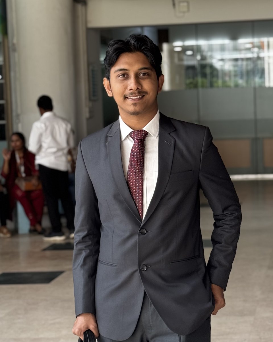 Shahparan Rimon in a grey suit with a briefcase