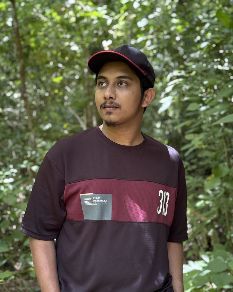 Shahparan Rimon in a cap among trees